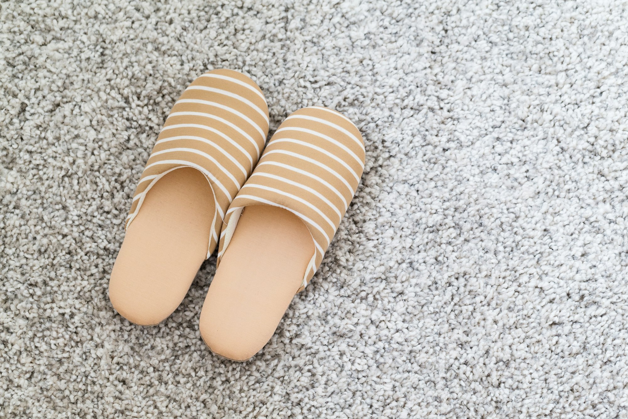 Soft brown color slippers on carpet
