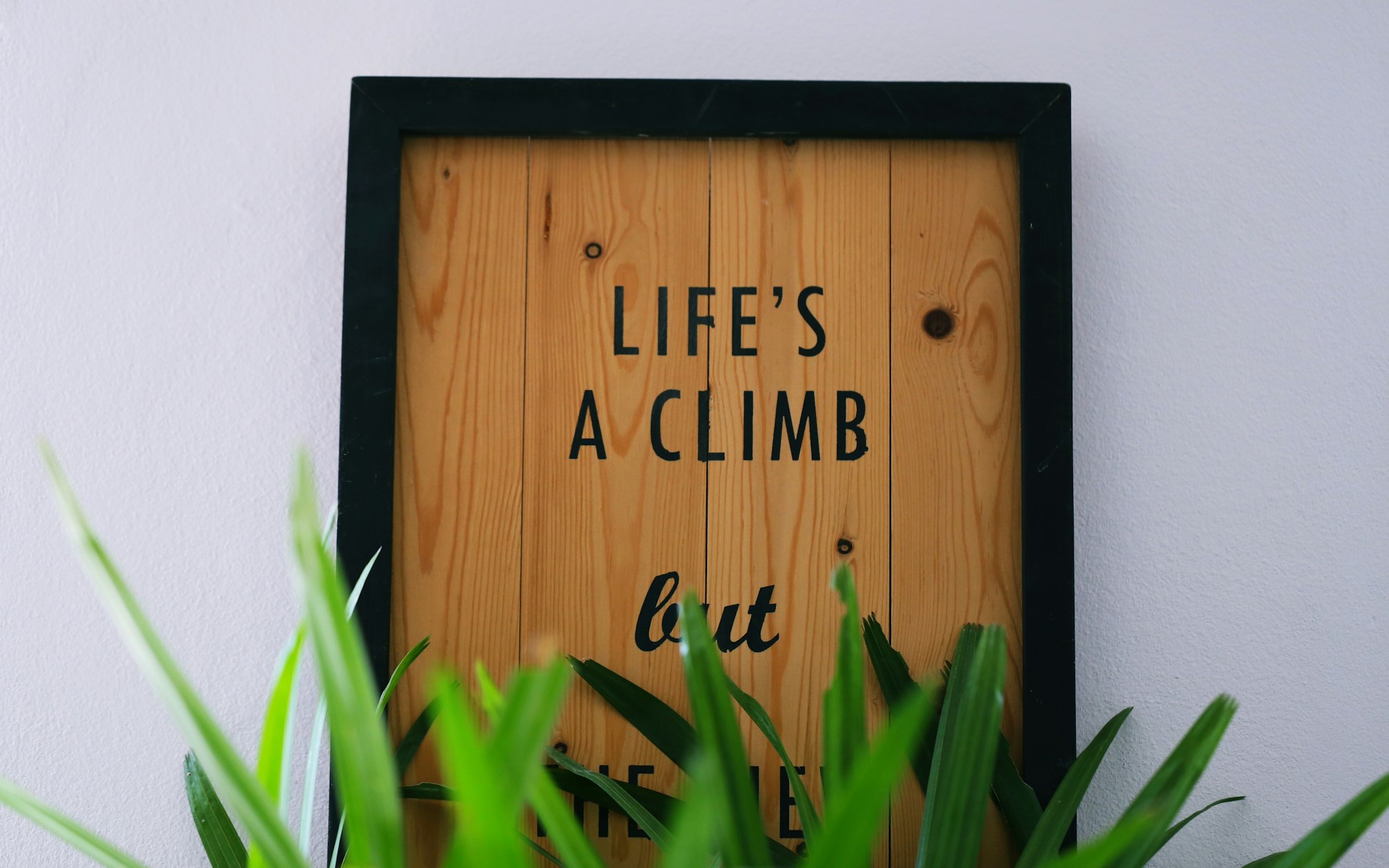 Wooden picture frame decoration hang on wall closeup interior blur background